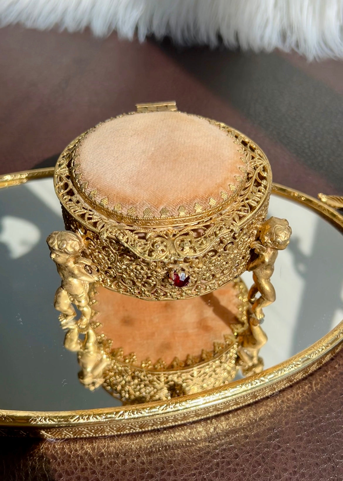 Three Footed Cherub Round Vintage Design Jewelry Casket/ Box with Pink Plush on the Top and Inside & Burgundy Red Stones Decoration