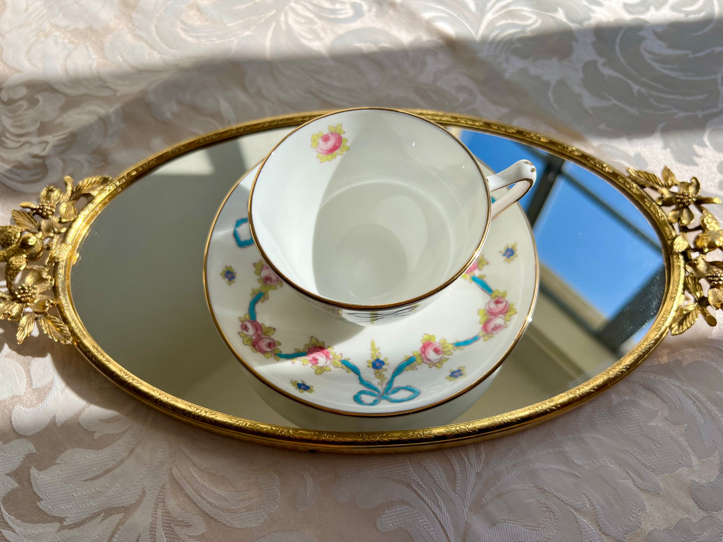 Crown Staffordshire bright blue enameled ribbon and looped bows pattern teacup and saucer