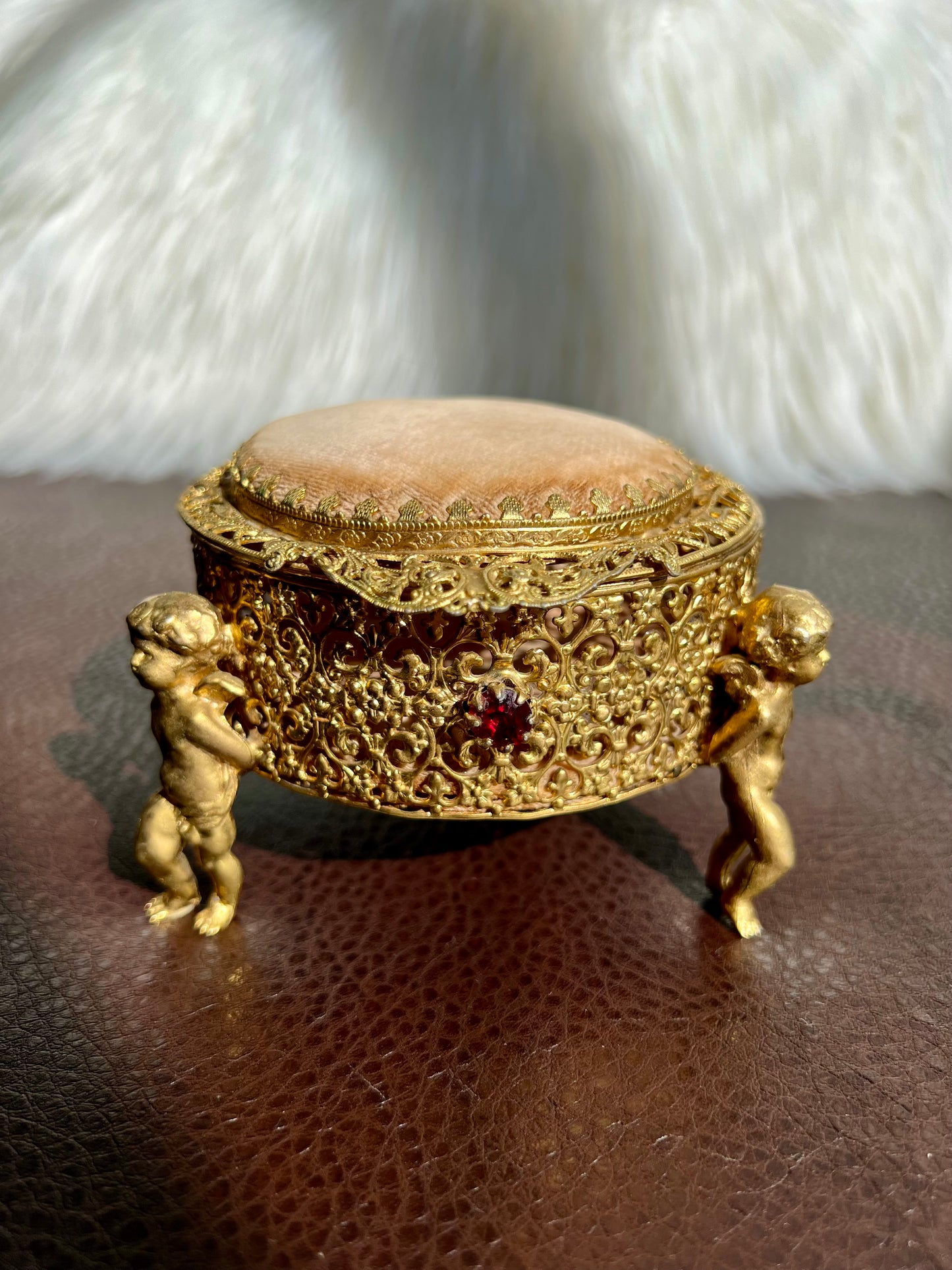 Three Footed Cherub Round Vintage Design Jewelry Casket/ Box with Pink Plush on the Top and Inside & Burgundy Red Stones Decoration